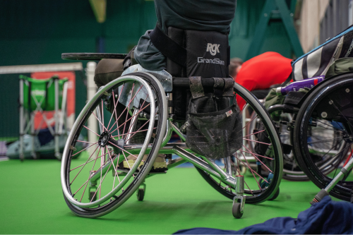 A wheelchair on a tennis court.