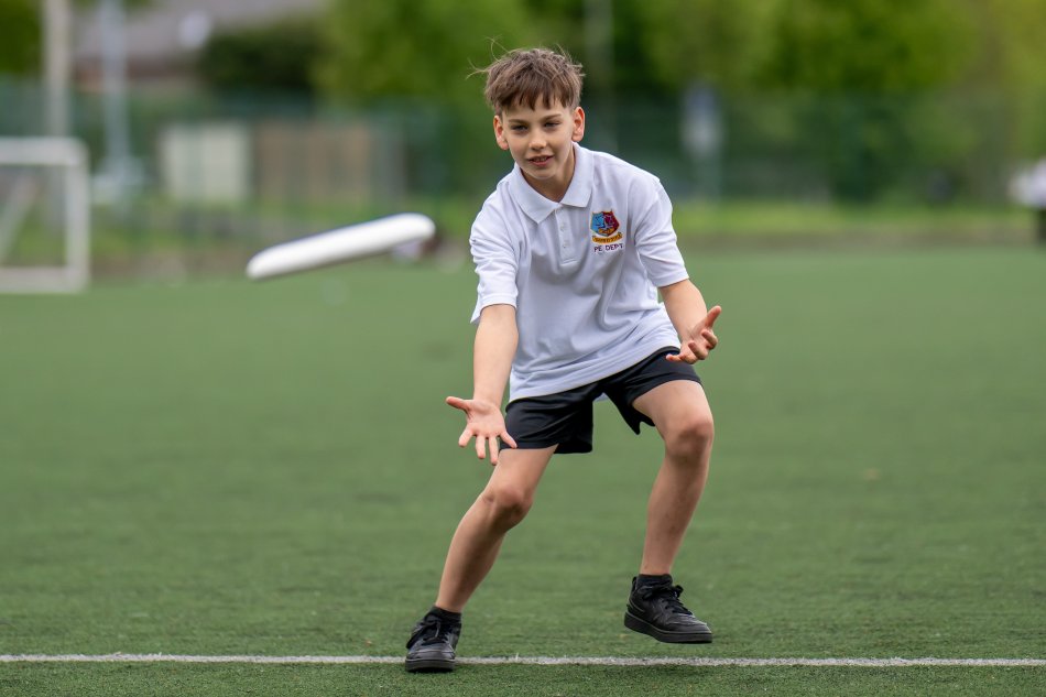 A boy playing with a frisbee